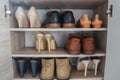 Fashionable women high heels and leather men shoes in wooden cabinet for going to work