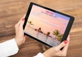 Woman reading travel blog on tablet