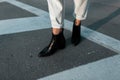Fashionable women`s black spring leather shoes. Stylish women`s shoes. Casual design. Close-up of female legs.