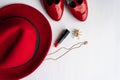 Fashionable women`s cosmetics and accessories flat lay in red color.