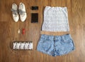 Fashionable women`s look. flat lay feminine clothes and accessories collage: lace top, denim shorts, clutch bag, shoes, camera, li