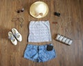 Fashionable women`s look. flat lay feminine clothes and accessories collage: lace top, denim shorts with a passport, clutch bag, s