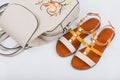 Fashionable women`s sandals and backpack on white background