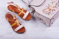 Fashionable women`s sandals and backpack on white wooden background Royalty Free Stock Photo