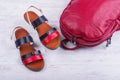 Fashionable women`s sandals and backpack on white wooden background Royalty Free Stock Photo