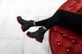 Fashionable women`s seasonal shoes. New autumn stylish collection footwear. Top view on female legs in black jeans in leather