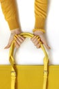Fashionable yellow on the bag and manicure.