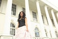 Fashionable Young African American Woman in Front of White Building