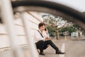 Fashionable young bearded man using a digital tablet , cheerfully smiling, watching or reading something funny, sitting on the Royalty Free Stock Photo