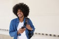 Fashionable young black man walking with cell phone Royalty Free Stock Photo