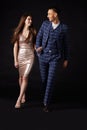 Fashionable young couple walking together arm in arm Royalty Free Stock Photo