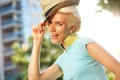Fashionable young lady smiling with hat outside Royalty Free Stock Photo