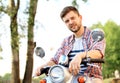 Fashionable young man riding a vintage scooter in street Royalty Free Stock Photo