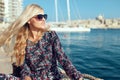 Fashionable young Mediterranean woman in floral pattern dress at sea