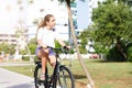 Fashionable young teen girl in shorts and t-shirt rides a bicycle in a summer park Royalty Free Stock Photo