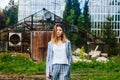 Fashionable young woman posing outside against grunge background