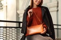 Fashionable young woman with stylish bag on city street, closeup. Space for text Royalty Free Stock Photo