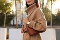 Fashionable young woman with stylish bag on city street, closeup Royalty Free Stock Photo