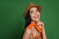 Fashionable young woman in stylish outfit with bandana on green background Royalty Free Stock Photo