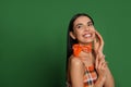 Fashionable young woman in stylish outfit with bandana on green background, space for text Royalty Free Stock Photo