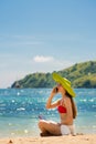 Fashionable young woman talking on mobile phone on the beach Royalty Free Stock Photo