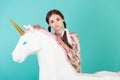 fashionable youth girl posing with big white unicorn