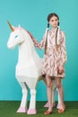 fashionable youth girl posing with big white unicorn