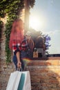 Fashionably dressed girl at the window of a boutique selling clothes. A woman holds a mini chihuahua in her arms. The pet is Royalty Free Stock Photo