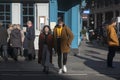 Fashionably dressed man and woman cross the road near Covent Garden on a sunny day