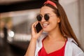 A stylish woman talking on the phone and smiling