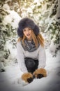 Attractive woman with brown fur cap and jacket enjoying the winter. Side view of fashionable blonde girl posing Royalty Free Stock Photo