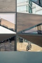 The fassade of a building reflects bicycles, street and building Royalty Free Stock Photo