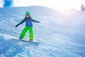 Fast action photo of boy go downhill on snowboard