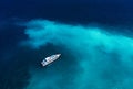 Fast boat at the sea in Bali, Indonesia. Aerial view of luxury floating boat on transparent turquoise water at sunny day. Seascape Royalty Free Stock Photo