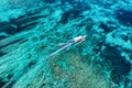 Fast boat at the sea in Bali, Indonesia. Aerial view of luxury floating boat on transparent turquoise water at sunny day. Seascape Royalty Free Stock Photo
