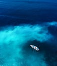 Fast boat at the sea in Bali, Indonesia. Aerial view of luxury floating boat on transparent blue water at sunny day. Summer seasca Royalty Free Stock Photo