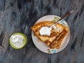 Fast breakfast with pancakes and sour cream top view