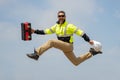 Fast building. Funny construction worker jumping. Excited jump of builders in helmet. Worker in hardhat. Construction