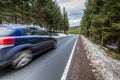 Fast car on a winter forest road Royalty Free Stock Photo