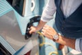 Fast charging of an electric car. man charging his electric car Royalty Free Stock Photo