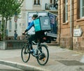 Fast delivery cyclist with Deliveroo bag
