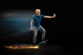 Fast delivery service - deliveryman on skateboard driving with order in fire on dark background