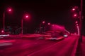 Fast driving traffic at night. Abstract blurred background of urban moving cars with bright brake lights at night. Auto, city