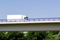 Fast driving white truck on a highway bridge Royalty Free Stock Photo