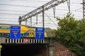 Fast Dutch train passing on the bridge with guidance signage street sign to Royalty Free Stock Photo