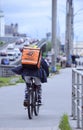 Fast express delivery service, courier rides byke in hurry on the street of the city