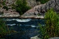 Fast flowing cold water mountain stream, flowing stormy stream stream, nature outdoors, fresh stream dark blue water Royalty Free Stock Photo