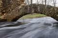 Fast flowing flood waters through stone arches