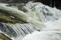 Fast flowing water over rocks Royalty Free Stock Photo