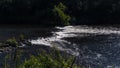 Fast flowing water on River Ave in Vila do Conde, Portugal. Bright sunny day in summer. Royalty Free Stock Photo